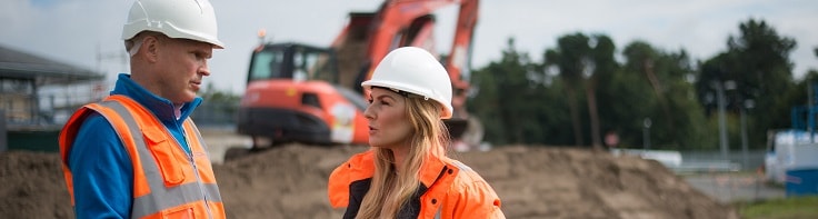 Employees talking on building site